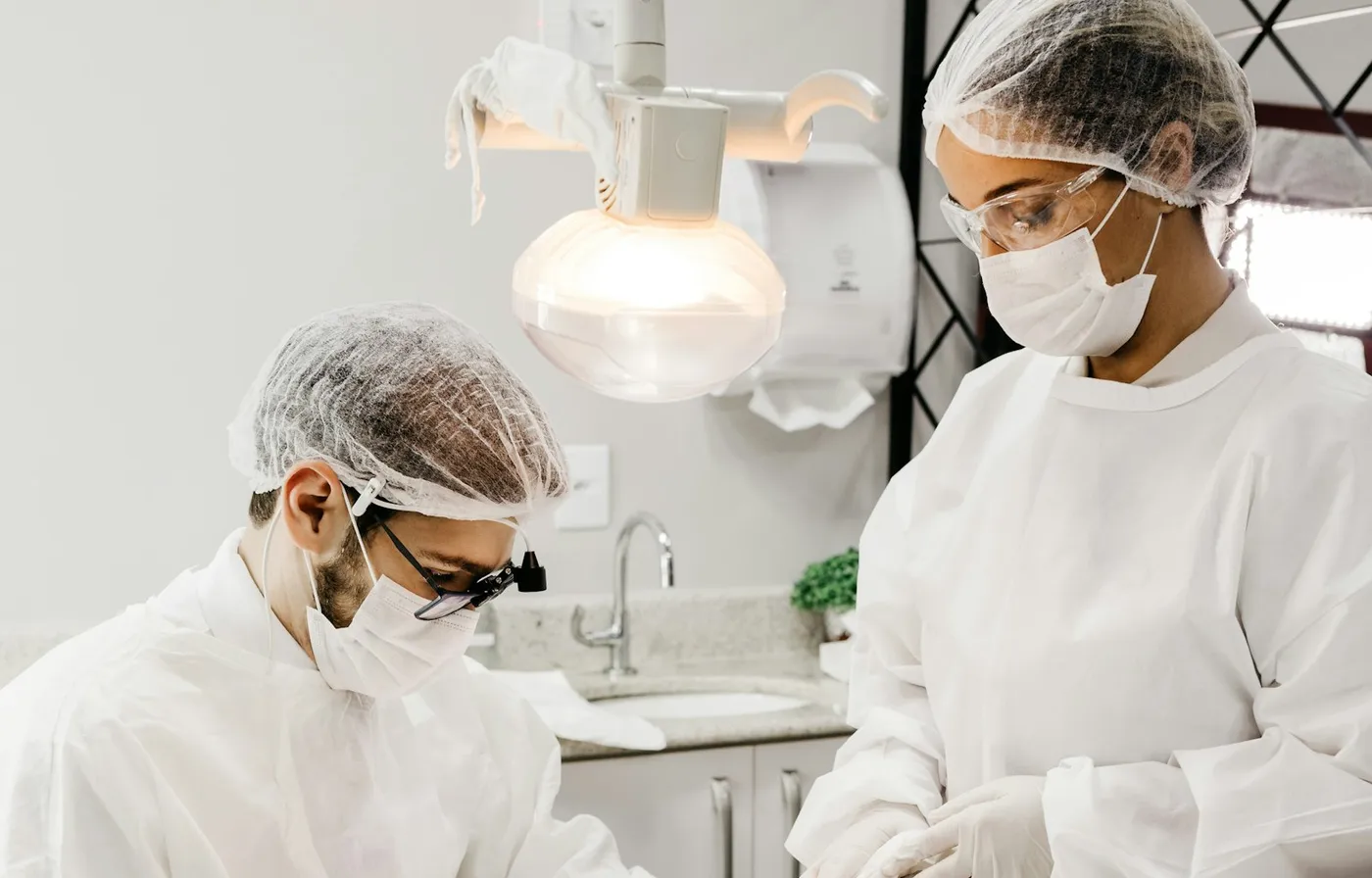 Dentist and assistant treating a patient in a dental clinic